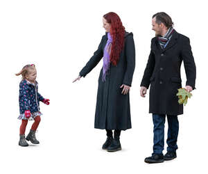 family with a little daughter picking leaves in the park