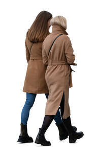 two women wearing camel overcoats walking