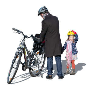 man and his daughter preparing to go bike riding
