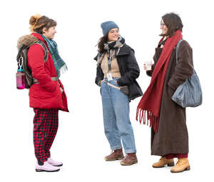 group of three women in winter standing and talking