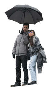 man and woman with an umbrella standing seen from below
