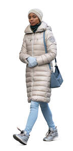 black woman wearing beige winter jacket walking