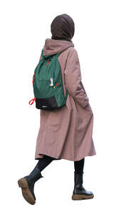 woman with a pink coat and green backpack walking
