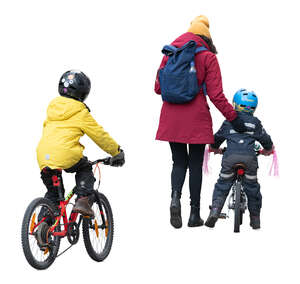 woman with two kinds on the bikes walking in the street