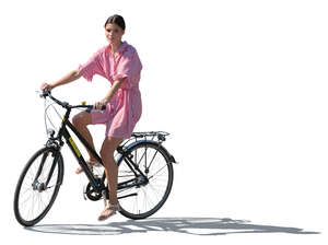 backlit woman in summer riding a bike