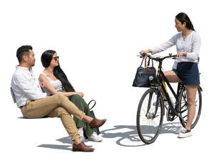 woman with a bike talking to two friends sitting on a bench