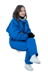 woman in a blue ski costume sitting