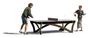 man and woman playing table tennis outside