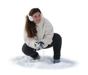 woman making snowballs in the snow for snow fight