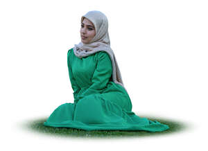muslim woman with a hijab sitting on the grass