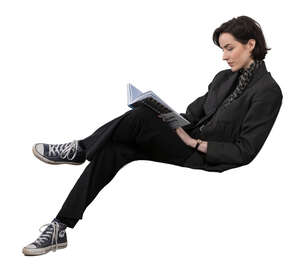 woman sitting on a sofa and reading a book