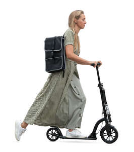 woman in a long summer dress riding a scooter