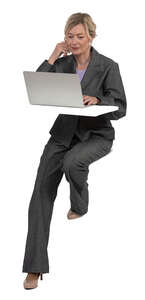 woman sitting at a counter table and working with laptop