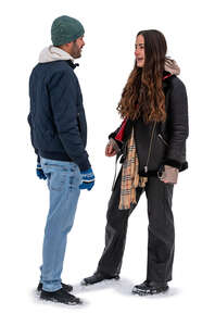 man and woman standing in the snow and talking