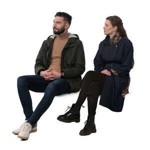 man and woman wearing overcoats sitting