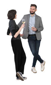 man and woman at a bar talking and drinking wine