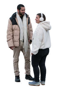 man and woman with with earmuffs standing and talking
