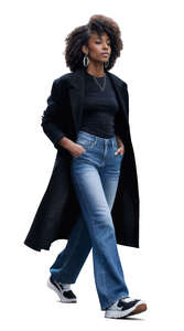 black woman with a black overcoat walking