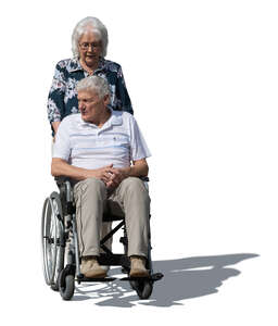 woman pushing an older man sitting in a wheelchair