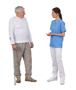 nurse talking to an elderly man with a walking stick