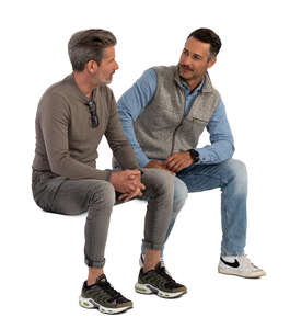 two cut out men sitting and talking