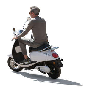 backlit man riding a white motor scooter