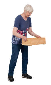 older lady lifting a wooden box