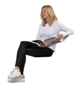 middle aged woman sitting and reading a magazine