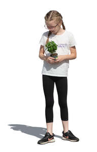 cut out little girl with a plant standing in the garden