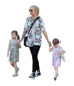 woman walking hand in hands with two kids 