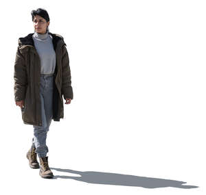 cut out backlit latino woman wearing a parka walking 