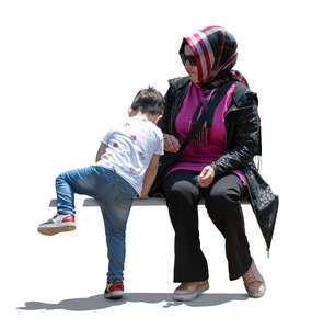 cut out backlit muslim woman sitting and playing with her son