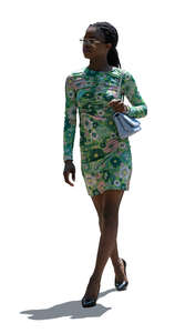 backlit black woman in a mini dress walking
