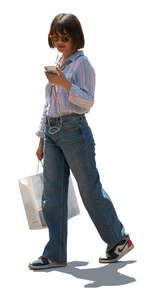 cut out backlit woman with a shopping bag and listening to music