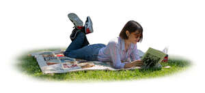 cut out woman lying in tree shade and reading a book