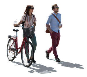 backlit woman and man walking in the street with coffee