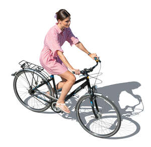 cut out woman in a summer dress riding a bike seen from above