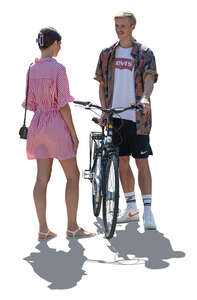 two cut out backlit people with a bike standing