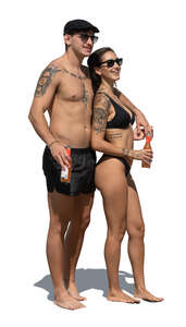 couple standing on the beach and drinking soda drinks