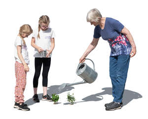 grandmother and grandkids planting in the garden