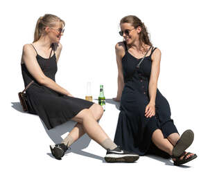 two women sitting outside and drinking