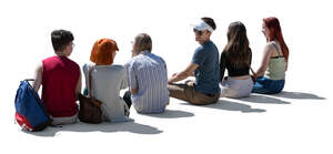 cut out backlit group of teenagers sitting