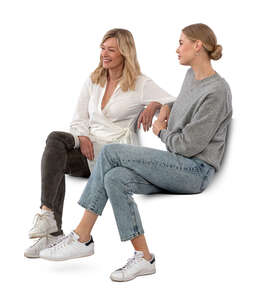 two women sitting and talking