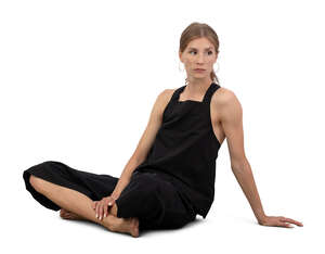 woman in black outfit sitting barefoot on the  ground