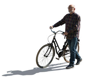 cut out backlit elderly man walking with a bike