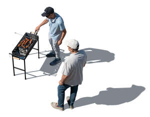 top view of two men grilling meat
