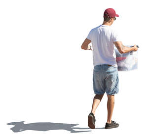 cut out sidelit man carrying a large box