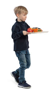 little boy walking with his lunch tray