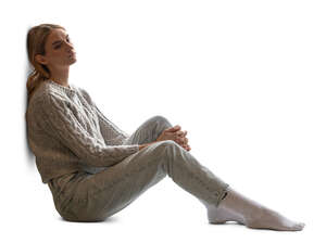 backlit woman sitting by the window