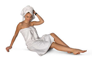 cut out woman wrapped in a bath towel relaxing in sauna